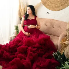 A moment of quiet reflection for the mom-to-be. Seated in a stunning red ruffled gown, this portrait captures the peaceful side of waiting for your baby.