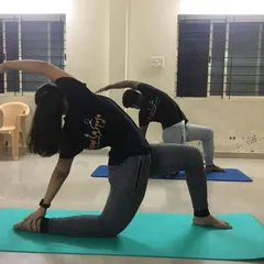 Students practicing a deep twisting lunge, which helps improve spinal flexibility and core strength. I guide the class to find their edge safely, ensuring everyone feels the benefits of the twist.