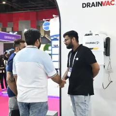 Here, a member of our team engages with a visitor at an exhibition, explaining the benefits of our Drainvac central vacuum system. We focus on educating clients about how this technology contributes to a cleaner, healthier home environment.