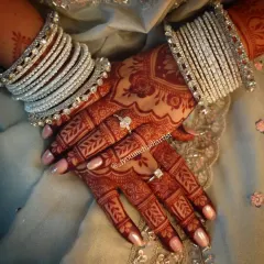 The final result is everything. This photo shows the deep, reddish-brown stain my organic henna achieves after setting. Paired with bridal bangles, the intricate patterns truly stand out, ensuring your hands look stunning on your big day.