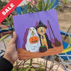 Spooky and sweet. This Halloween-themed painting features two dogs in ghost and witch costumes, perfect for the season.