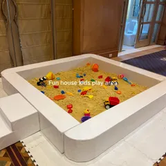 Our portable sandpit set up indoors on a protective mat. This shows how we can bring the beach experience to any room without worrying about the mess.