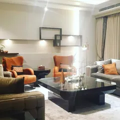 This is a recently completed hall design in Gurgaon, where the client wanted a classic, comfortable, and luxurious feel. I used a mix of plush sofas, warm accent chairs, and layered lighting to create an inviting and elegant living space.