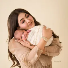 A mother's gentle embrace. This close-up shot captures the profound bond and overwhelming love between a mother and her newborn.