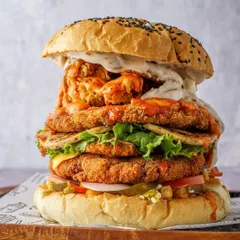Another angle of this epic burger, showcasing the layers and textures. My goal is to make the food look as delicious and larger-than-life as it tastes, creating a must-try appeal for customers.