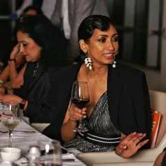 This is a perfect example of an unscripted moment I love to capture. A guest enjoying a conversation over a glass of wine at a dinner party. My event photography focuses on these real, relaxed expressions that truly reflect the atmosphere of your gathering.
