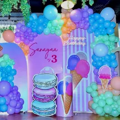 A sweet setup for a third birthday with a "Candyland" theme. We used pastel balloon arches and large cutouts of ice cream and macarons to create a delicious-looking party space.