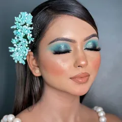 This shot highlights the intensity of the blue glitter eyeshadow. I always ensure that even with bold colors, the skin looks fresh and radiant, not heavy or overdone.