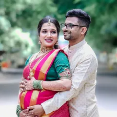 A beautiful candid moment from a Seemantham shoot, capturing the couple's happiness and the traditional elegance of their attire.