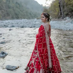 The bride looking back with a smile while standing in the river. A beautiful and adventurous bridal portrait.