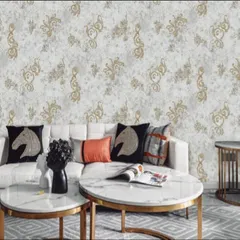 This wallpaper features an elegant pattern with gold accents on a light, textured background. It's a great choice for a formal living room, adding a touch of luxury and sophistication that pairs well with modern furniture.