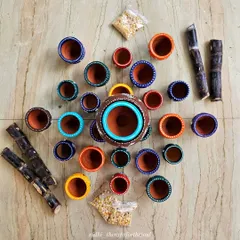 A top-down view of the painted pots, sugarcane, and grains before I created the final festive arrangement. I love the bright colors on the rims of the pots.