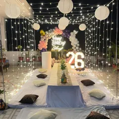 For this 26th birthday, we created a beautiful canopy of fairy lights and paper lanterns over a comfortable floor seating arrangement, making the terrace feel like a private oasis.