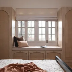 This bedroom showcases my love for natural textures and smart storage solutions. I used rattan on the arched wardrobe doors and under-window cabinets to bring warmth and timeless elegance, creating a bright and airy retreat that feels both classic and contemporary.