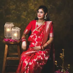 A solo portrait of the mom-to-be, looking radiant in her traditional attire. The props, like the brass lamp and lanterns, add to the authentic feel.