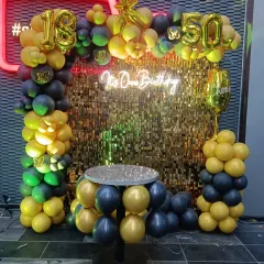 When birthday twins celebrate together! This striking black and gold setup for an 18th and 50th birthday features a sequin wall, a balloon table, and foil numbers for both milestones.