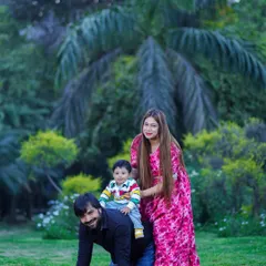 Playful moments make the best memories. An outdoor family shoot is the perfect opportunity for piggyback rides and genuine giggles. The lush green background makes the family's colorful outfits pop.