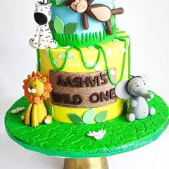 A close-up of the bottom tier of Aashvi's 'Wild One' jungle cake. I love creating these detailed scenes with edible textures and adorable, friendly animals.