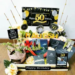 Celebrating a 50th birthday is a golden moment, and this hamper is designed to match. It features a sophisticated black and gold theme, a live plant, premium goodies, and personalized elements like a name display and photo memories.