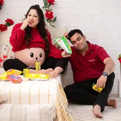 The aftermath of the snack party. This funny and relatable portrait captures the couple in a moment of playful exhaustion, surrounded by their favorite treats.