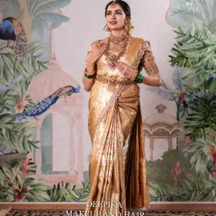 A full-length portrait of a South Indian bride in a magnificent golden Kanjeevaram saree. This showcases the complete look, from the elegant saree drape to the flawless makeup and confident posture.