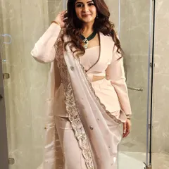 This is what I call power dressing with a soul. A modern, powder peach cutout powersuit paired with a traditional zardozi dupatta creates a look that is both authoritative and authentic, perfect for making a statement at any high-profile event.