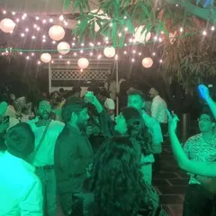 An English and South Indian fusion wedding party, with guests enjoying the outdoor setting.