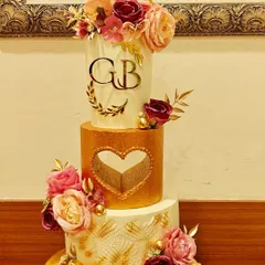 Another view of the 50th anniversary cake. The combination of white, gold, and florals creates an elegant and timeless look, perfect for celebrating half a century of love.