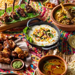 A colorful and festive spread of modern Indian cuisine. We use rich textures and props to create a visually dense image that reflects the complexity of the flavors.