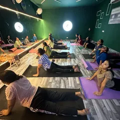 Our members holding the cobra stretch, or Bhujangasana, a fantastic yoga pose for strengthening the spine and opening the chest. You can see the focus and form in this group setting, reflected in the studio's mirrored wall.