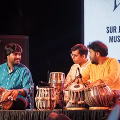A moment of interaction during a percussion ensemble at the Surjyotsna concert. Sharing the stage with dholki and sambal players creates a rich and powerful rhythmic tapestry.