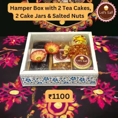 A beautifully arranged hamper box with two tea cakes, two cake jars, and salted nuts, presented in a decorative box with a clear lid. This is a great option for corporate Diwali gifts.
