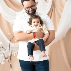 A father holds his smiling son in this heartwarming portrait. These photos celebrate the special bond between a dad and his child.