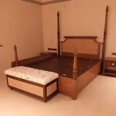 A classic four-poster bed made from solid wood with turned posts and a cane headboard. I also built the matching storage bench at the foot of the bed. This style of furniture has a long history and brings a sense of heritage to a room.