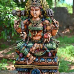 A 30-inch sculpture of Goddess Shri Devi (Amman) holding her divine weapons, the Tirishul (trident) and Udukkai (drum). The antique, multi-colored finish gives her a powerful and ancient presence.