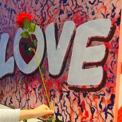 Spread the love with a hand-painted typography piece. This vibrant "LOVE" painting is a perfect gift or a cheerful addition to a bedroom, adding a pop of color and a positive message.