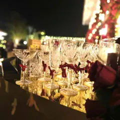 The beauty is in the details. We selected exquisite crystal glassware, each adorned with a small red ribbon, to complement the scarlet and gold theme of this elegant Navjote celebration, ensuring every element felt special.