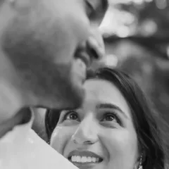 A candid black and white shot capturing the pure adoration in a bride's eyes as she looks up at her partner.