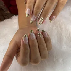 This stunning set features intricate, 3D gold chrome bows and elegant gold tips. It's a perfect example of a luxurious and detailed manicure.
