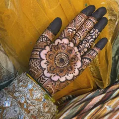 A beautiful mandala design, perfectly placed on the back of the hand. The dark fingertips provide a stunning contrast.