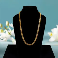 For jewelry catalogs, I shoot pieces on a classic black bust. This ensures customers see the exact shape, size, and detail of the product, like this elegant gold chain, helping them make a confident purchase.