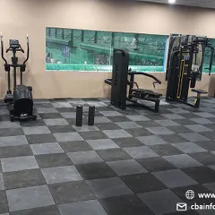 A view of our cardio and strength training zone, featuring treadmills, ellipticals, and multi-station gym machines for comprehensive workouts.