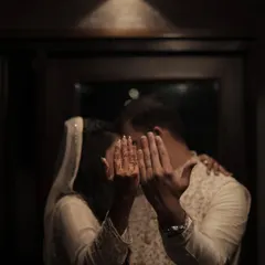 A playful and intimate "reveal" of the rings. This candid style of ring photography captures the couple's personality and the happy reality of being newly engaged.