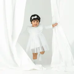 A game of peek-a-boo between the curtains. These spontaneous, joyful moments create the most authentic and timeless toddler portraits.