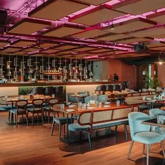 This wide view of a resto-bar in Hennur showcases my approach to hospitality design. I created a dynamic atmosphere with varied seating zones, dramatic ceiling acoustics, and a prominent bar, perfect for both intimate dinners and lively social gatherings.