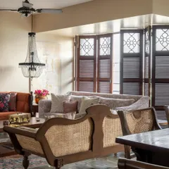 We wanted this living room to feel like it had always been there. The cane-back bench, louvered wooden shutters, and a mix of seating create a relaxed, layered atmosphere. The light filtering through the shutters casts a gentle glow, perfect for long afternoons spent with family.