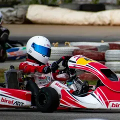 Driver in kart number 42 navigating a corner, with another competitor in the background. Our driver coaching focuses on maintaining composure and precision during close-quarters racing.