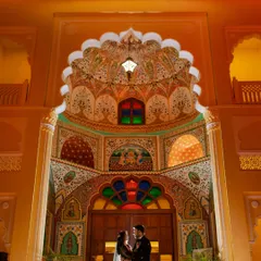 A stunning portrait of Tanmay and Dipika at the iconic Patrika Gate. The vibrant, intricate archways provide a colorful and uniquely Jaipur backdrop for a sangeet night portrait that is both grand and intimate.