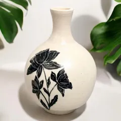 Enhance your interior design with the classic elegance of this hand-painted ceramic vase. The bold, black floral design makes it a unique and artistic enhancement for your home.