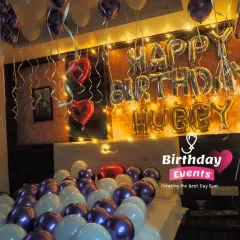 A romantic surprise for a husband's birthday. This bedroom decor features purple and white balloons, heart-shaped foils, and a "Happy Birthday Hubby" message.